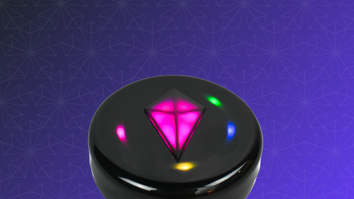 Product render: Totem Compass with a glowing pink Touch Crystal and pink, green, blue and yellow Bond lights on a purple patterned background